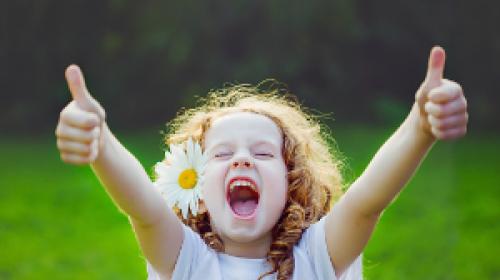 A child giving two thumbs up